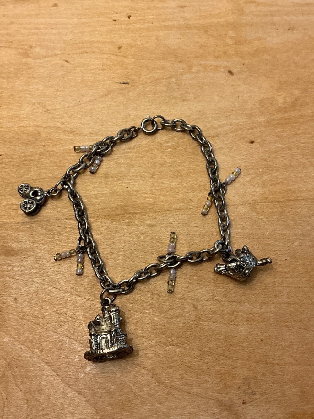 Silver tone charm bracelet Castle Carriage Crown beaded